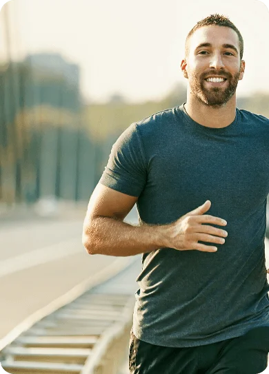 Muscular man jogging outdoors, representing immunity boost.